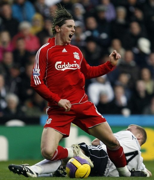 Fernando Torres lucha por el control del balón con un adversario.