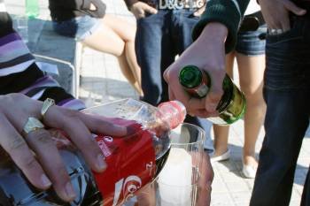 Dos jóvenes preparan una bebida durante un botellón, un fenómeno que se pretende erradicar. (Foto: ARCHIVO)